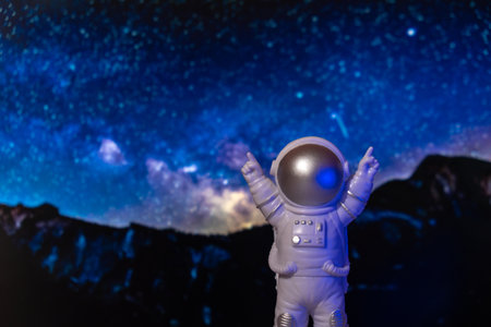 Plastic toy astronaut on universe planets background Copy space. Concept of out of earth travel, private spaceman commercial flights. Space missions and Sustainabilityの写真素材
