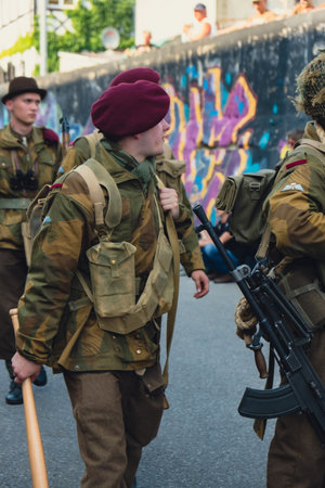 Hel, Poland - August 2022 Military troops marching during 3 May Polish Constitution Day ceremonial patriotic parade. Polish armed forces tanker military parade. old guns and cars. Feast of Polish Armed Forces Day, American soldiers with US flag on parade のeditorial素材