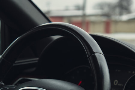 Black luxury modern car Interior. Steering wheel, shift lever and dashboard. Detail Automatic gear...