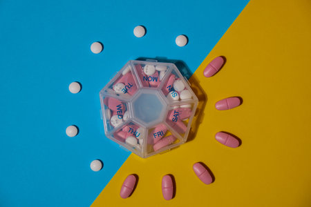 Organizer weekly shots medical pill box with doses of tablets for daily take medicine with white...