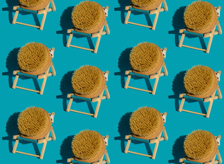 Pattern of Dry massage brush on beach chair with natural bristle, ecological cosmetics, home care. Bamboo Brush for dry anti-cellulite massage. Spa beauty conceptの写真素材