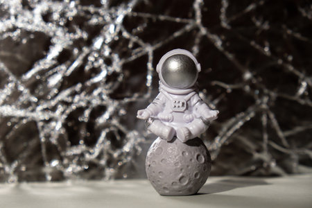 Plastic toy figure astronaut on silver background Copy space. Concept of out of earth travel, private spaceman commercial flights missions and Sustainabilityの写真素材
