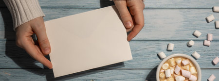 Banner Female hands holding empty greeting or invitation card mock up with white cup of coffee and...