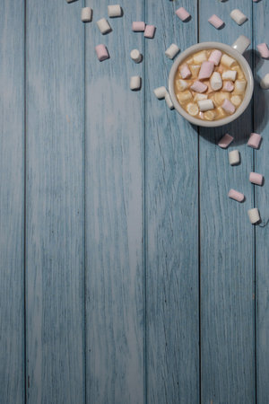 Empty greeting or invitation card mock up with white cup of coffee and marshmallows on wooden blue background. Design wallpaper Frame copy space for your text. Valentines day, Happy fathers mothers day, Womens day holidayの写真素材
