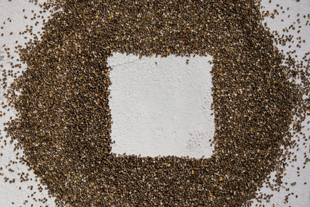 Chia seeds frame background with copy space. Healthy superfood rich in Omega 3 fatty acids. Dry healthy natural ingredient. Chia grains are fallingの写真素材