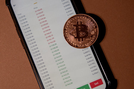 Bitcoin gold coin on background of Stock Market Chart. Bitcoin mining trading concept. BTC golden money. Worldwide virtual internet Cryptocurrency or crypto digital payment systemの写真素材