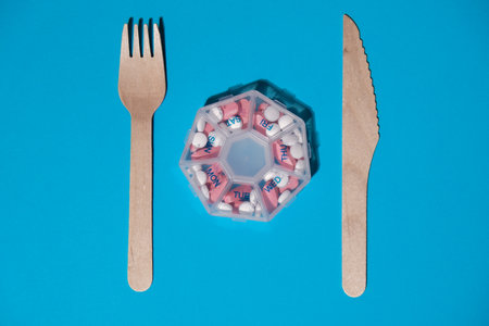 Organizer weekly shots with fork and knife medical pill box with doses of tablets for daily take...