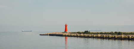 Lighthouse on blue sea line. Waves on sunny day on Baltic sea. Gdansk Poland. Swimming by ship to lighthouseの写真素材