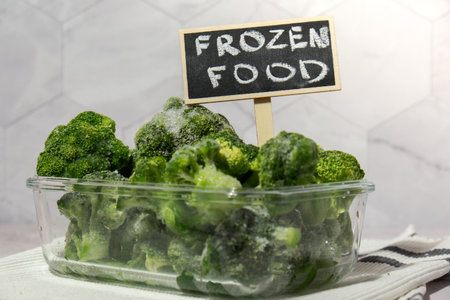 Frozen food broccoli florets with blackboard label and text FROZEN FOOD homemade. Harvesting concept. Stocking up vegetables for winter storage. Healthy foodの写真素材