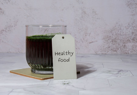 Blue-green algae Chlorella and spirulina powder drink with paper note text HEALTHY FOOD. Super powder. Natural supplement of algae. Detox superfood drink cocktail. Food supplement source of protein and beta caroteneの写真素材
