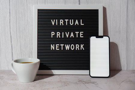 Letter board with text of VIRTUAL PRIVATE NETWORK VPN with mobile phone white screen mock up template for your copy space app application creation Internet protocols for protection private network anonymous safe and secure internet accessの写真素材