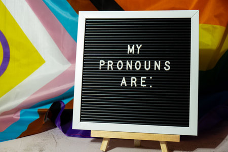 MY PRONOUNS ARE text Neo pronouns concept on Rainbow flag background gender pronouns. Non-binary people rights transgenders. Lgbtq community support assume my gender tolerance equal rightsの写真素材