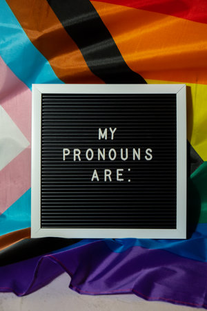 MY PRONOUNS ARE text Neo pronouns concept on Rainbow flag background gender pronouns. Non-binary people rights transgenders. Lgbtq community support assume my gender tolerance equal rightsの写真素材