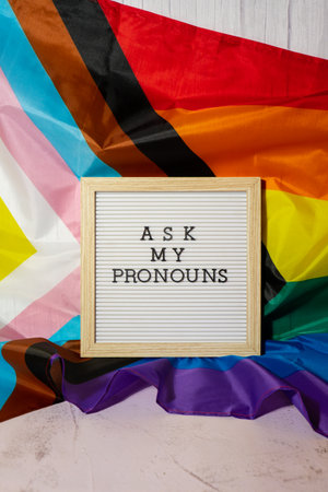 ASK MY PRONOUNS text Neo pronouns concept on Rainbow flag background gender pronouns. Non-binary people rights transgenders. Lgbtq community support assume my gender tolerance equal rightsの写真素材