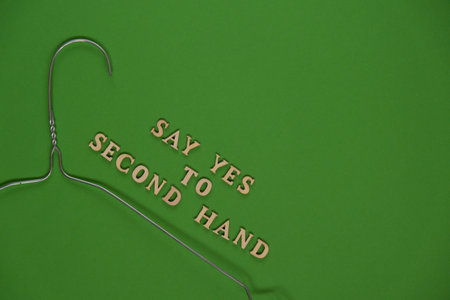 SAY YES TO SECOND HAND text with clothes rack. Second hand sustainable shopping. Capsule minimal wardrobe. Sustainable fashion overconsumption, conscious buying consumption, slow fashionの写真素材
