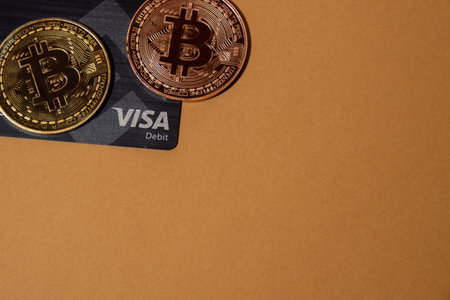 Gdansk Poland - May 2022 Bitcoin gold coin with Black Binance Card mining trading concept. Visa debit card BNB, Binance Exchange Card to buy bitcoin BTC golden money. Worldwide virtual internet Cryptocurrency or crypto digital payment system. Digital coinのeditorial素材