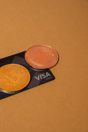 Gdansk Poland - May 2022 Bitcoin gold coin with Black Binance Card mining trading concept. Visa...