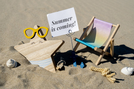 SUMMER IS COMING text on paper greeting card on background of beach chair lounge starfish summer...