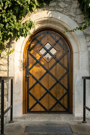 Wine cellar built from stones with violet flowers on foreground in Wawel Castle Krakow, Poland. Blooming in flower bed at courtyard. Spring flowers blossoming in sunny spring day, background stone medievalの写真素材
