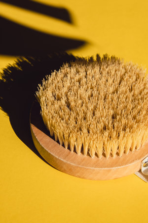 Dry massage brush with natural bristle, ecological cosmetics, home care. Bamboo Brush for dry anti-cellulite massage. Spa beauty conceptの写真素材