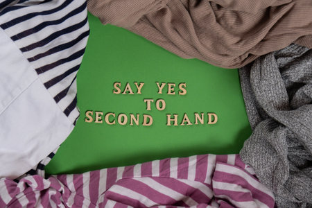 SAY YES TO SECOND HAND text on clothes assortment Second hand sustainable shopping. Capsule minimal wardrobe. Sustainable fashion overconsumption, conscious buying consumption, slow fashionの写真素材