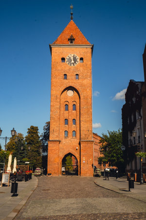 Elblag, Poland - August 2022. St. Nicholas Cathedral Gothic tower View on the Market Gate and the main cathedral street of old town. Architecture of Elblag. City skyline Historical city in northern Polandのeditorial素材