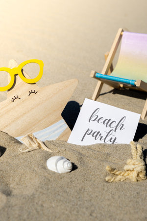 BEACH PARTY text on paper greeting card on background of beach chair lounge starfish summer vacation decor. Sandy beach sun. Holiday concept postcard. Travelの写真素材