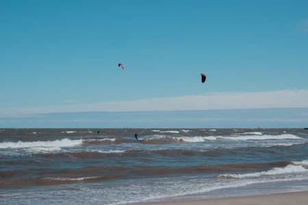 Wing Foiling kitesurfing wind surfing water outdoor sport in Baltic sea Dark blue clouds ocean water...