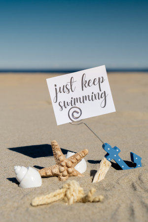 JUST KEEP SWIMMING text on paper greeting card in anchor paper holder and starfish seashell summer...
