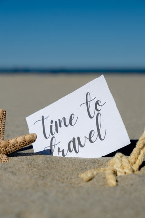 TIME TO TRAVEL text on paper greeting card on background of starfish seashell summer vacation decor. Sandy beach sun coast. Holiday concept postcard. Getting away Travelの写真素材