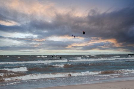 Wing Foiling kitesurfing wind surfing water outdoor sport in Baltic sea Dark blue clouds ocean water surface with foam waves before storm, dramatic seascapeの写真素材