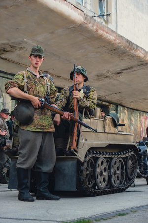Hel, Poland - August 2022 Military troops marching during 3 May Polish Constitution Day ceremonial patriotic parade. Old guns and cars. Feast of Polish Armed Forces Day, American soldiers with flag on parade Nato Vehicles Military Equipmentのeditorial素材