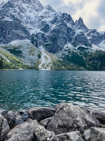 Morskie Oko lake Snowy Mountain Hut in Polish Tatry mountains, Zakopane, Poland. Beautiful green...