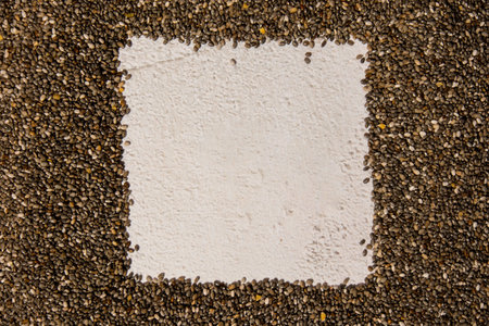 Chia seeds frame background with copy space. Healthy superfood rich in Omega 3 fatty acids. Dry healthy natural ingredient. Chia grains are fallingの写真素材
