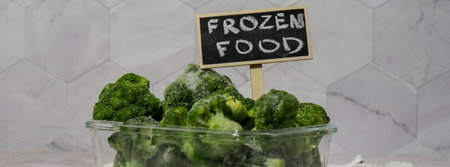 Frozen food broccoli florets with blackboard label and text FROZEN FOOD homemade. Harvesting concept. Stocking up vegetables for winter storage. Healthy foodの写真素材