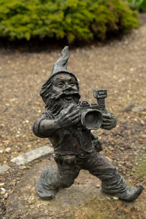 Dwarf with camera - photographer. Small bronze figures of gnomes on the streets of Wroclaw. Europe Miniature bronze figure of a gnome. Symbol of Wroclawの写真素材