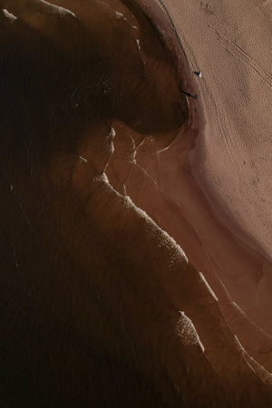 Drone aerial view of waves sea ocean coast. Beach and dunes dark calm sea waves nature landscape captured with drone. Tourismの写真素材