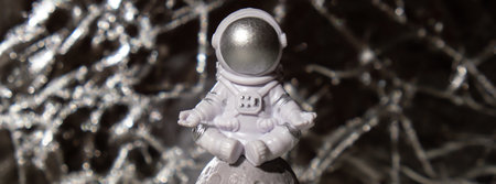 Plastic toy figure astronaut on silver background Copy space. Concept of out of earth travel, private spaceman commercial flights missions and Sustainabilityの写真素材