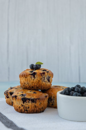 Homemade baked blueberry muffins with fresh blackberries. Tasty pastry sweet cupcake dessert. Berry pie cupcakes with organic berries. Gluten free healthcare recipe from alternative flourの写真素材