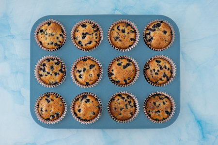 Fresh baked blueberry muffins. Tasty Sweet cupcake top view flat lay. Pastry homemade dessert. Berry...