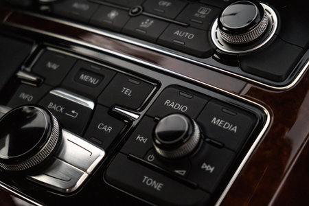 Interior of modern luxury car. Details of automatic transmission gear shift, multimedia control...