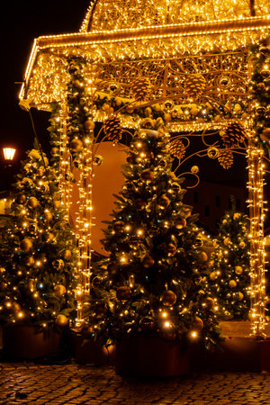 Holiday Decorated and illuminated street at night in Gdansk Poland. Beautiful Christmas fair in the old town at night. Advent winter time in Europe background. Markets in December Ornamented for celebrationの写真素材