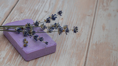 Lavender soap on wooden background with copy space for your text. Advertisement template mock up. Skincare homemade natural cosmetic concept. Organic dry lavender flowerの写真素材