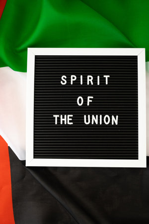 Text SPIRIT OF THE UNION on background flag of UAE. National holiday of United Arab Emirates....