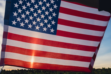 Waving American Flag on sun Background. Flag of the united states of America. July 4th Independence...