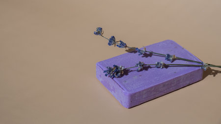 Lavender soap on beige background with copy space for your text. Advertisement template mock up. Skincare homemade natural cosmetic concept. Organic dry lavender flowerの写真素材