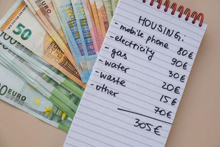 Counting expenses bills on housing electricity, gas, water. Banknotes of euro cash around. High prices for energy inflation crisis. Cut back on spending. Savings rateの写真素材