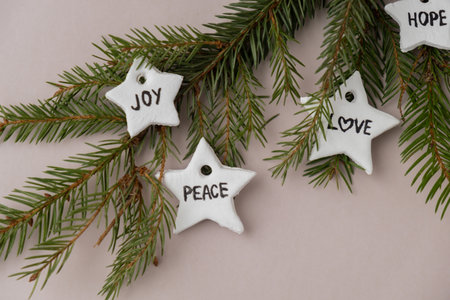 Christmas star with words HOPE JOY PEACE LOVEGroup of air dry clay handmade Christmas decor on beige...