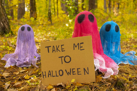 Creative handmade Halloween holiday decoration. Colorful ghost with cardboard HAPPY HALLOWEEN...