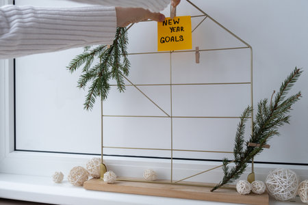 Unrecognizable woman creating action board new years resolutions on colorful sticky notes. Making promises for new year, setting goals. Dream yearの写真素材